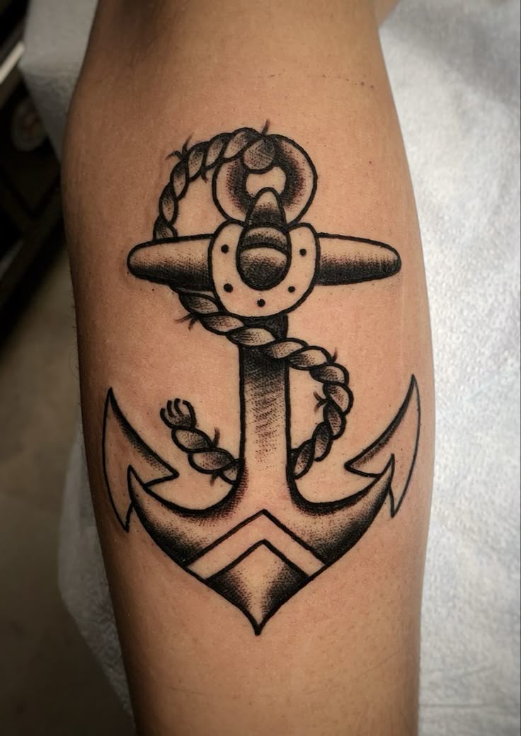 Black work traditional anchor tattoo.