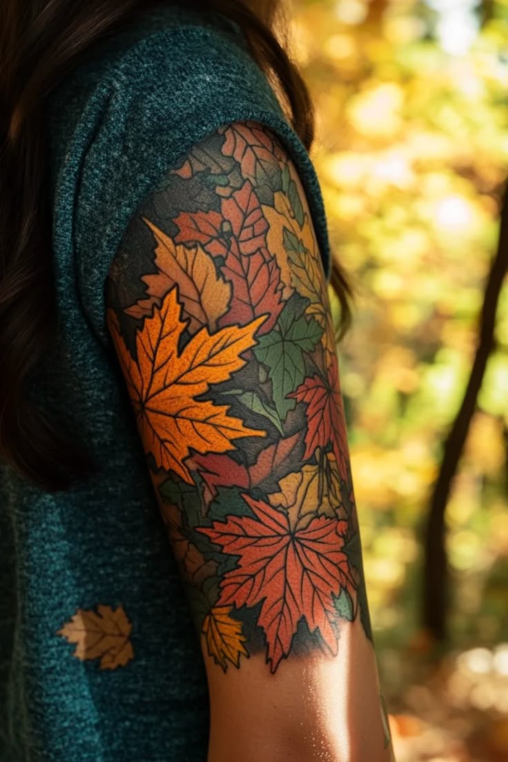 Layered orange, red, and green maple leaves wrap the upper arm over deep black shading.