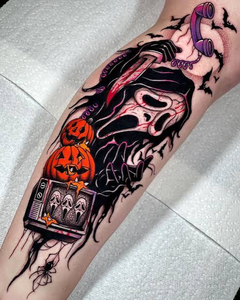 Ghostface tattoo with orange pumpkins, bats, a pink phone, and a small TV showing screaming faces.