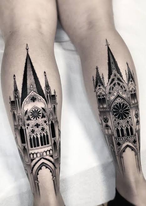 Matching blackwork cathedral tattoos with tall spires and rose windows on both calves