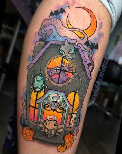 Kawaii ghost cat haunted house tattoo on the upper arm shows a purple house with glowing windows and tiny pumpkins.