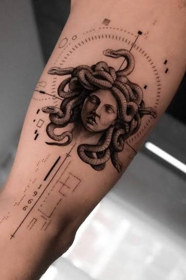 Circular dotwork frames a calm Medusa portrait, with long lines and small geometric shapes down the forearm.