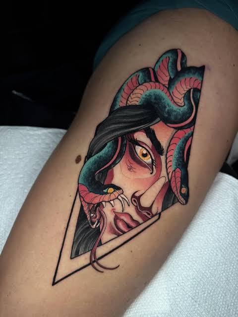 Teal and coral snakes frame Medusa’s golden eye, with a forked tongue extending past a pointed upper arm border.