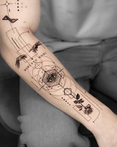 Geometric forearm tattoo with an eye inside overlapping circles and a small rose near the wrist.