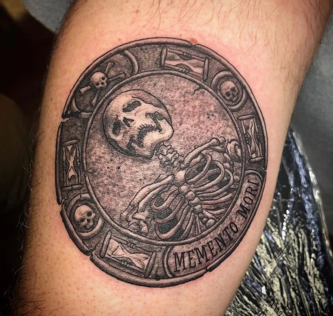 Skeleton portrait inside a cracked oval medallion bordered by skulls, hourglasses, and curved lettering.