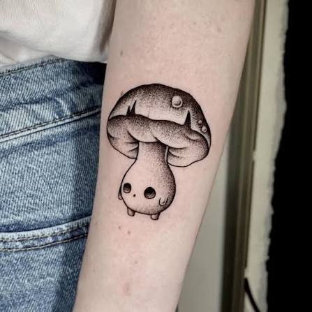 Cute mushroom character with dot eyes, tiny feet, and fine black stippling on the forearm.