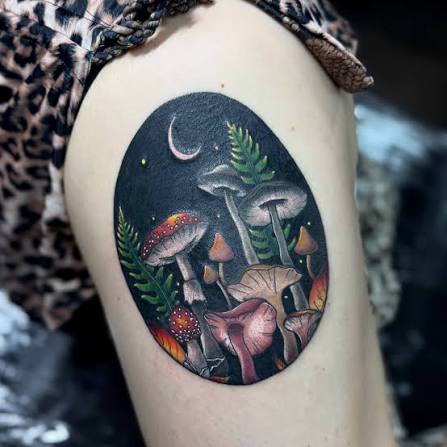 Dusky mushrooms, green ferns, and a slim moon framed as a midnight forest on the upper arm.