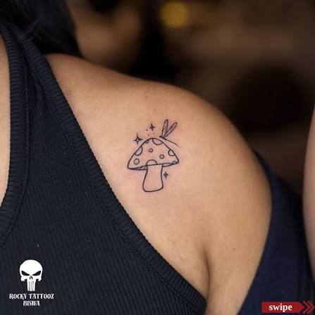 Fine line mushroom, small sparkles, and a delicate sprig on the shoulder.