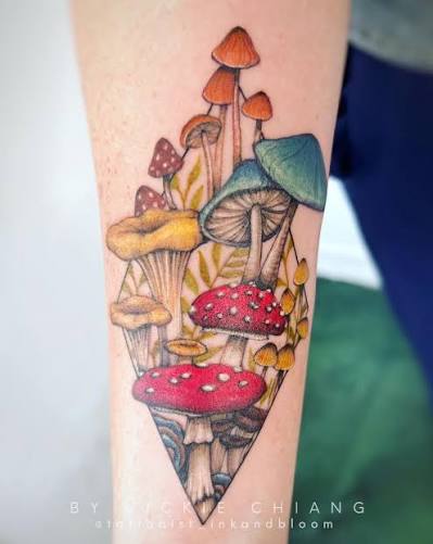Red, gold, and teal mushroom cluster in a slim storybook design on the forearm.