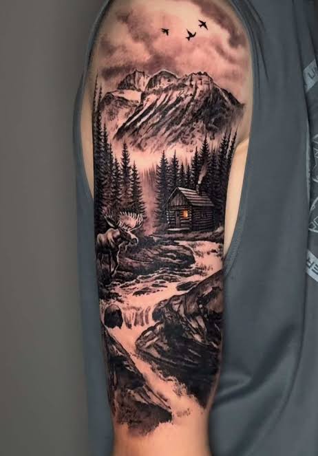 Black and gray mountain scene with a cabin, moose, pine trees, and waterfall on the upper arm
