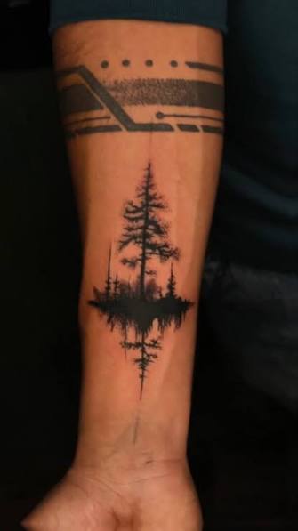 Lone pine tree with a dark reflection stretching down the inner forearm