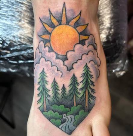 Orange sun and pink clouds above a pine forest, with a stream flowing from ankle to foot