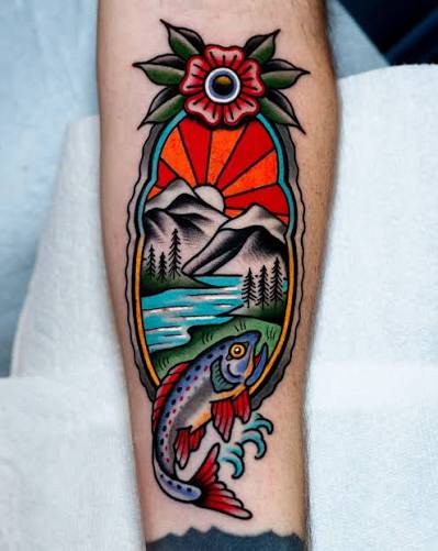 Spotted trout below snowy mountains and a red sunset, topped with a flower on the forearm