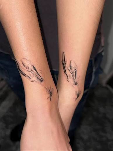 Fine line skeletal hands reaching toward each other across two inner wrists