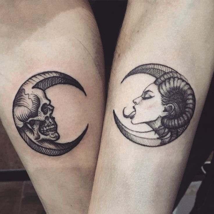 Paired crescent moon tattoos featuring a skull and a horned maiden on facing forearms