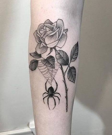 Dotwork rose and spiderweb tattoo with a spider hanging below the petals on the forearm.