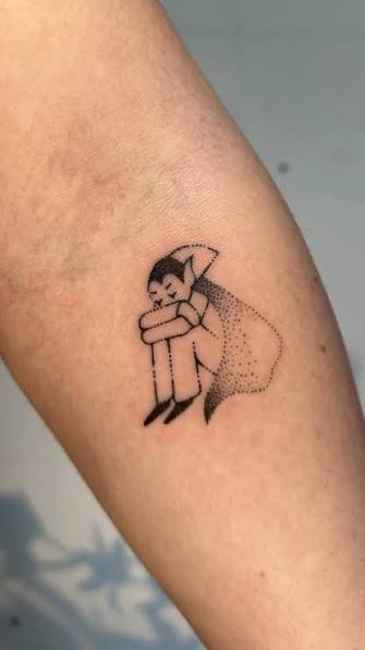 Tiny crouching vampire boy hugging his knees beneath a dotted cape