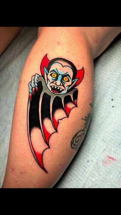 Old school bat vampire with bright red wings and a wild fanged grin curving along the calf