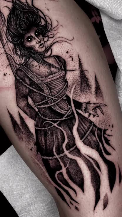 A bound witch tattoo with rope, smoky roots, and a clawed hand reaching from the trees on the thigh.